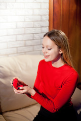 Young beautiful girl holding her engagement ring in excitement