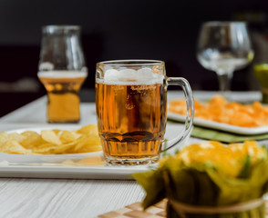 Beer and chips on the large white table