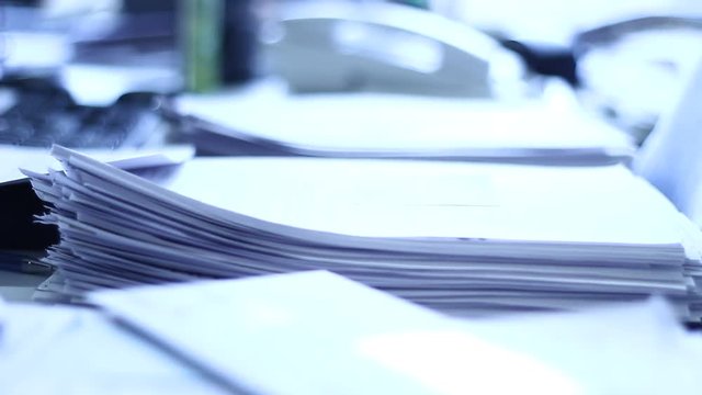 Close up of paper stacks, unsolved paper documents in the office. Shallow DOF. Suitable for backgrounds.