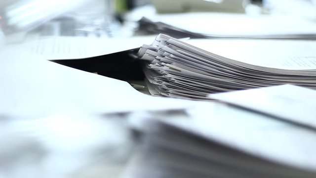 Close up of paper stacks, unsolved paper documents in the office. Shallow DOF. Suitable for backgrounds.