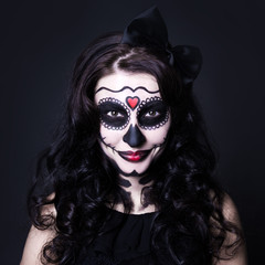 woman with Halloween skull make up over black