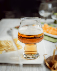 Beer and chips on the large white table