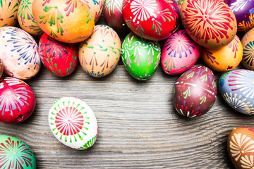 Top View Colorful Easter Eggs on Wooden Background.
