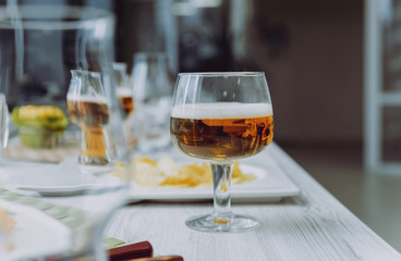 Beer and chips on the large white table