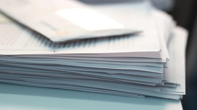 Close up of paper stacks, unsolved paper documents in the office. Shallow DOF. Suitable for backgrounds.