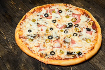 Top view of Italian rustic PIZZA on wooden table background