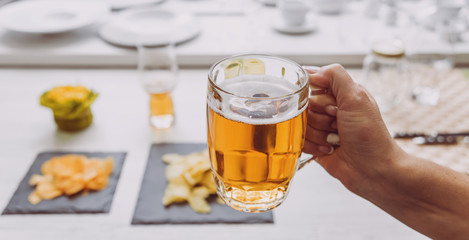 Glass of lager beer in the hands