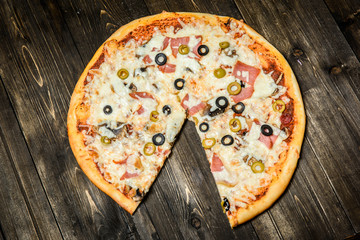 Top view of Italian rustic PIZZA on wooden table background