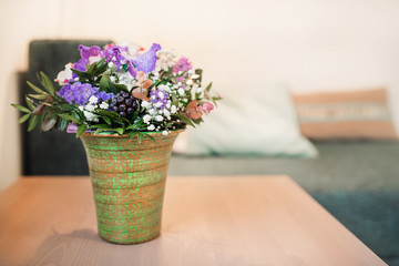 Flower pot at table in hotel room