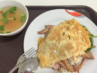 omelet on top of roast chicken with rice and  spicy soup