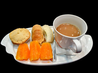 coffee break set , fruits , bakery and coffee on black background