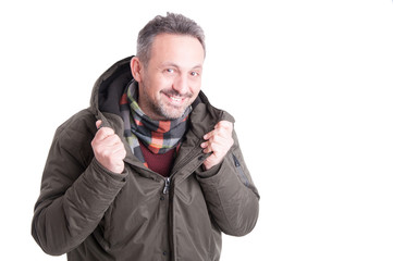 Man showing winter his comforter under winter jacket