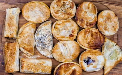 Meat and vegetable pies on the wooden table