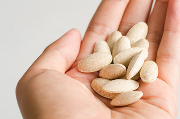 Fototapeta na wymiar Medicine herb in hand,Alternative Medicine,Herbal supplement pill