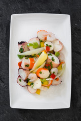 Traditional seafood ceviche from Peru on slate.Top view
