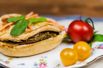 Meat and vegetable pies on the wooden table