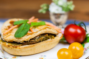 Meat and vegetable pies on the wooden table