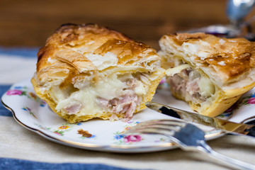 Meat and vegetable pie on the silver plate with sauces
