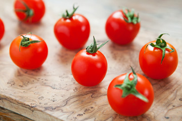 Fresh cherry tomatoes on a wooden background. Top view with copy