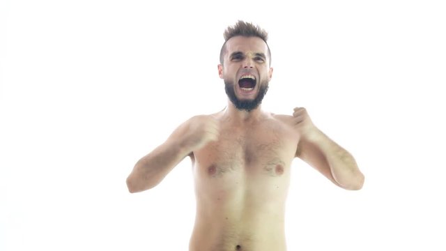 Furious bearded naked man showing his strong body, studio isolated on white background.