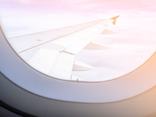 Looking out the aircraft window, saw the plane wing in the morning sunrise