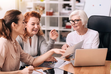 Delighted businesswomen creating the project at work