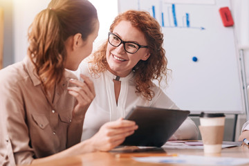 Friendly businesswomen talking in the office
