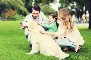 happy family with labrador retriever dog in park