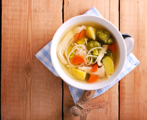Chicken noodle soup with broccoli in a bowl