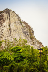 Golden Buddha laser carved and inlayed with gold on Khao Chee Chan Cliff. One of most famous landscape located in Sattahip, Chonburi province, Thailand.