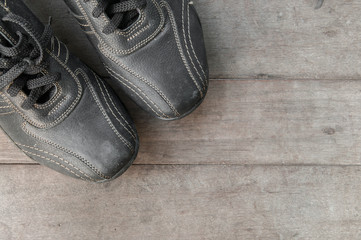 Fototapeta na wymiar Black leather shoe on wooden board.