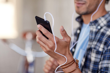 man with earphones and smartphone listening music