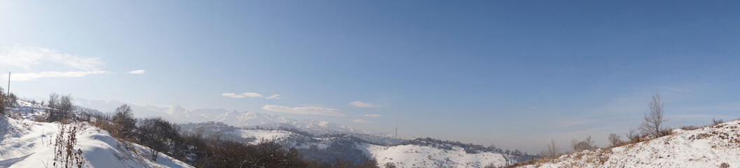 Winter landscape. View of the city and surrounding area. The mountains.