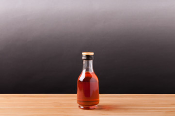 Whisky in bottle on wooden table.