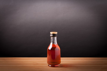 Whisky in bottle on wooden table.