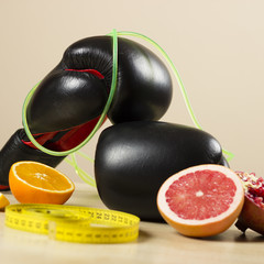 Various fruits neatly placed on the wooden table. Tape measurement beside them.