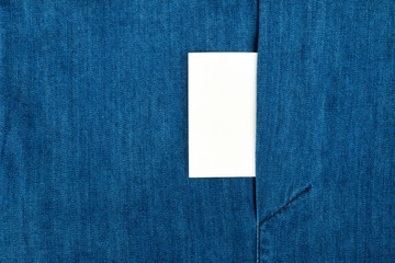 Blank business card with copy space in a pocket of blue jean jacket.