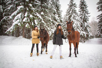 Fototapeta na wymiar Twin sisters and horse in the winter forest