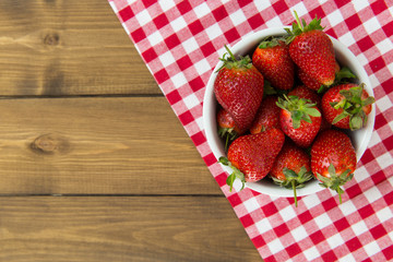 Strawberries in bowl on tablecloth