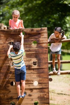 Kids Playing On A Playground Ride In Park