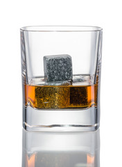 Stones in glass of whiskey on white background