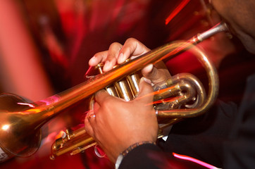 Fototapeta na wymiar Trumpet player with red background.