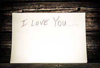 On a white sheet of paper written in Sharpie "I love you"

