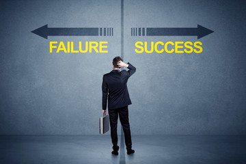 Businessman standing in front of success and failure arrow conce