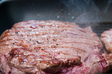 Steak dinner cooking on the grill
