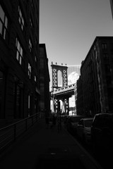 Manhattan bridge and silhouette of buildings in black and white style, Brooklyn, New York