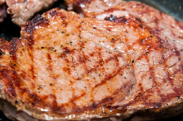 Obraz na płótnie Canvas Steak dinner cooking on the grill