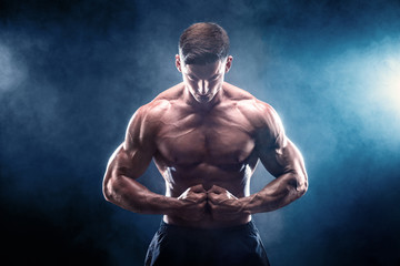 Strong bodybuilder man with perfect abs, shoulders,biceps, triceps, chest.