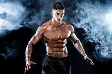 Strong bodybuilder man with perfect abs, shoulders,biceps, triceps, chest.