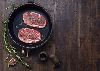 Pork steak with rosemary, garlic and pepper , top view , free sp